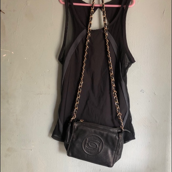 A nice black shirt w/ BeBe purse